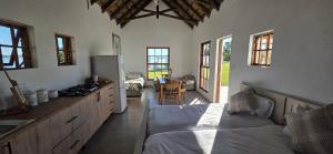 a kitchen and living room with a bed in a room at Mooring Manor Chalet in Vaal Marina
