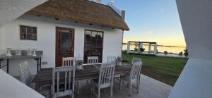 a house with a wooden table and chairs at Mooring Manor Chalet in Vaal Marina +7 photos