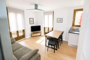 a living room with a table and a couch at Apartaments Angelina in La Pobla de Segur