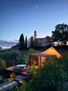 a gazebo with a table and a tent at Stecadó Glamping in Dolceacqua