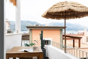 a balcony with a table and a cactus and umbrella at Begani63 Boutique Apartments in Gaeta +41 photos