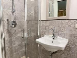 a bathroom with a sink and a shower at Casa Mariarosa in Volterra
