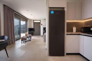 a room with a kitchen and a living room at Lina's Luxury Villas in Skala