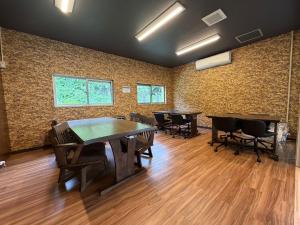 a room with ping pong tables and chairs in it at Rich Reson Ishigaki in Ishigaki Island