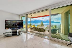 a living room with a large window with a view at Spacious 3BR Lakeview Apartment with Terrace by GuestLee in Montreux