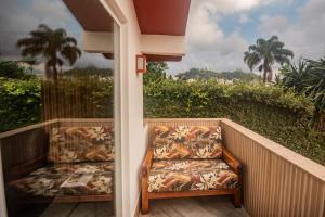 a porch with two chairs sitting on a balcony at Pousada Imperial Koeler in Petrópolis
