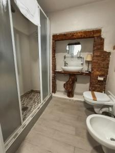 a bathroom with a sink and a toilet and a mirror at Franciacorta White in Cellatica +39 photos