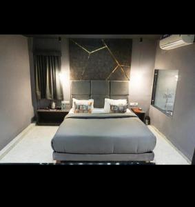 a bedroom with a large bed in a room at Kanakplace in Indore