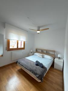 a bedroom with a bed and a ceiling fan at Alameda in Jaca