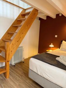 a bedroom with a loft bed and a staircase at Jardim da Trindade in Coimbra