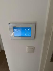 a clock on the side of a white door at Stillvolle Apartment NV in Neukirchen-Vluyn