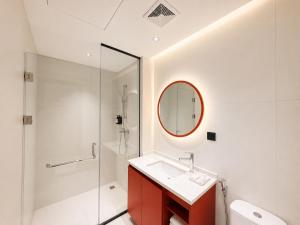a bathroom with a shower and a sink and a mirror at SHANKEE Hotel Melawai Blok M Jakarta in Jakarta +25 photos