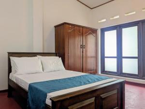 a bedroom with a bed with a wooden headboard and a window at Seth Villa Matara in Matara +53 photos