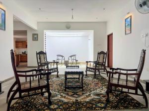 a group of chairs and a table in a room at Seth Villa Matara in Matara