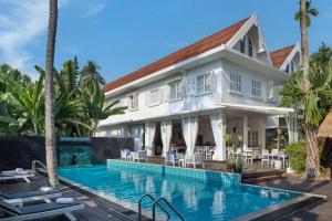 a villa with a swimming pool and a resort at Homm Souvannaphoum Luang Prabang, part of Banyan Group in Luang Prabang