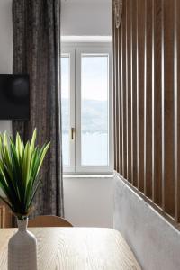 a room with a vase on a table with a window at Begani63 Boutique Apartments in Gaeta