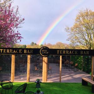 a rainbow over the entrance to a terrace bar at Hotel Eighteen92 in Liverpool