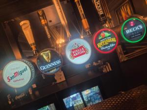 a group of signs on the wall of a bar at Hotel Eighteen92 in Liverpool