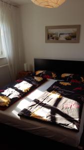 a bedroom with two beds with clothes on them at Ferienhaus Sonnenpier in Putbus