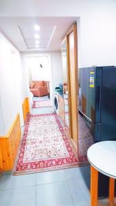 a small kitchen with a refrigerator and a table at Domi Chalet in Hurghada