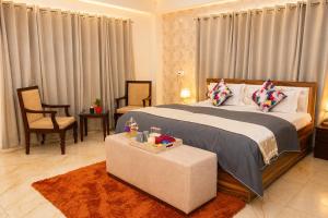 a bedroom with a bed and a table and chairs at Noon Villa in Kanethi +35 photos