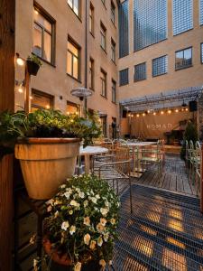 a patio with tables and potted plants in a building at City Backpackers Hostel in Stockholm