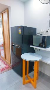 a table in front of a black refrigerator at Domi Chalet in Hurghada