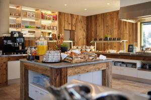 a kitchen with a counter with food on it at Explorer Hotel Bayrischzell in Bayrischzell