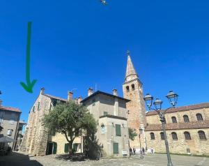 an old building with a tower and a church at Calle del Palazzo 12 in Grado