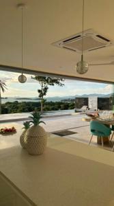 a kitchen with a table and a plant on a counter at Villa Bardi - Breathtaking Sea View in Plai Laem