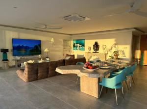 a living room with a table and a couch at Villa Bardi - Breathtaking Sea View in Plai Laem