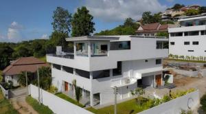 a white building with a lot of windows at Villa Bardi - Breathtaking Sea View in Plai Laem