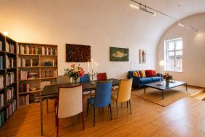 a living room with a table and chairs and a couch at Schloss Hollenburg Aparte Apartments in Krems an der Donau