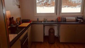 a kitchen with a counter and a sink and a window at Ferienwohnung Am Hummerstein in Ebermannstadt
