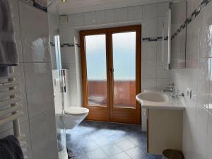 a bathroom with a toilet and a sink at Ferienhaus Riedberg in Ried im Zillertal +31 photos