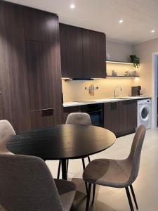 a kitchen with a table and chairs and a sink at East Apartment in Egilsstaðir