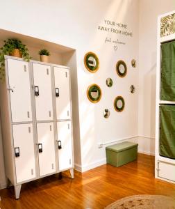 a room with two white cabinets and a wall with plates at Ria Surf & Stay in Faro
