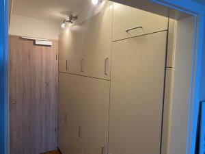 a room with white cabinets and a closet at Fördeblick Anna in Glücksburg