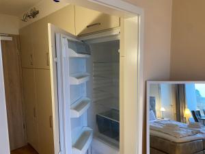 a room with a closet with white shelves and a bed at Fördeblick Anna in Glücksburg