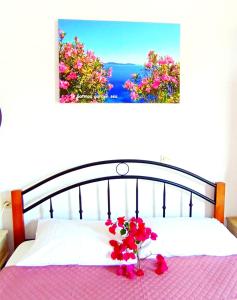 a bedroom with a bed with a vase of flowers at Patmos Garden Sea in Grikos +50 photos