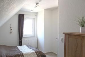 a bedroom with a bed and a window at Jonas in Rerik