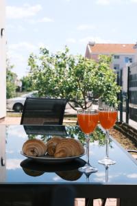 a table with a plate of bread and two wine glasses at Bokun Gušta in Trogir +21 photos