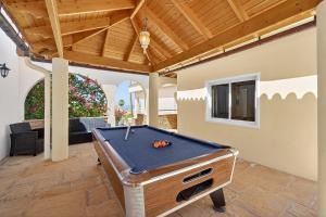 a pool table in the middle of a patio at Spacious Villa Victoria Heated Pool in Callao Salvaje