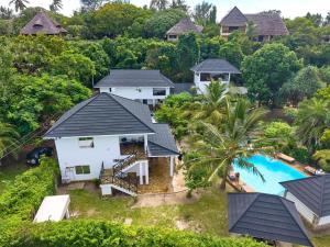 an aerial view of a villa with a swimming pool at Coast Sun Gardens Cottage Adults Only in Msambweni