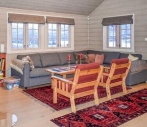 a living room with a couch and a table and chairs at Bakkestølveien 360 in Hol