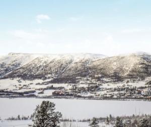 a view of a snowy mountain with a lake at Bakkestølveien 360 in Hol