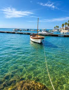 a boat tied to a dock in the water at Largo Spani 15 in Veglie