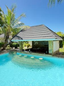 a swimming pool with a gazebo on top of it at Coast Sun Gardens Cottage Adults Only in Msambweni +66 photos