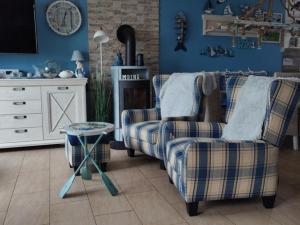 a living room with two chairs and a tv at Fischers Fritze in Fehmarn