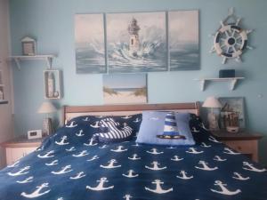 a bedroom with a bed with a blue comforter with nordic at Fischers Fritze in Fehmarn +14 photos